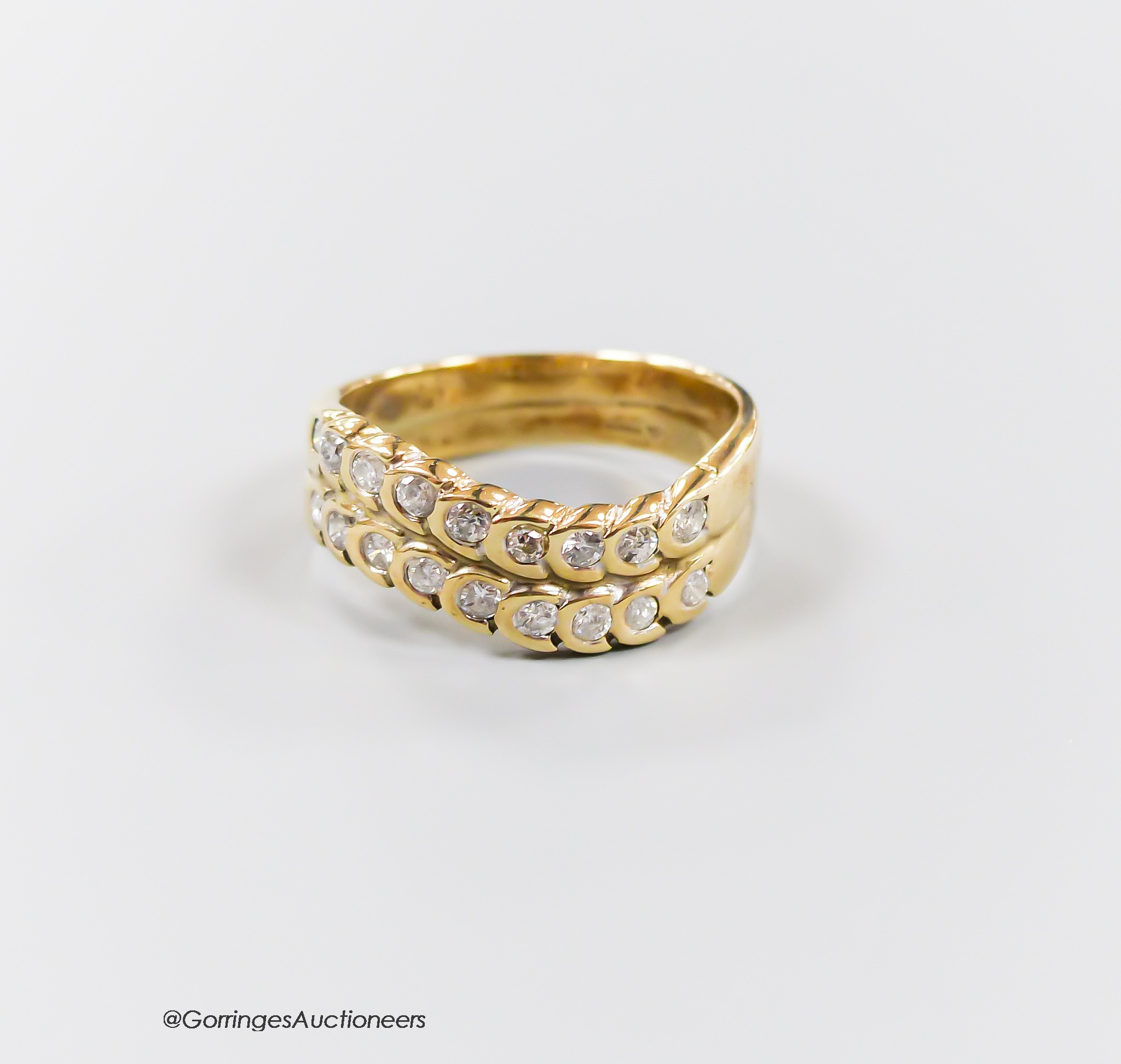 A modern 9ct gold and two row diamond set half hoop ring, size O, gross 4.6 grams.